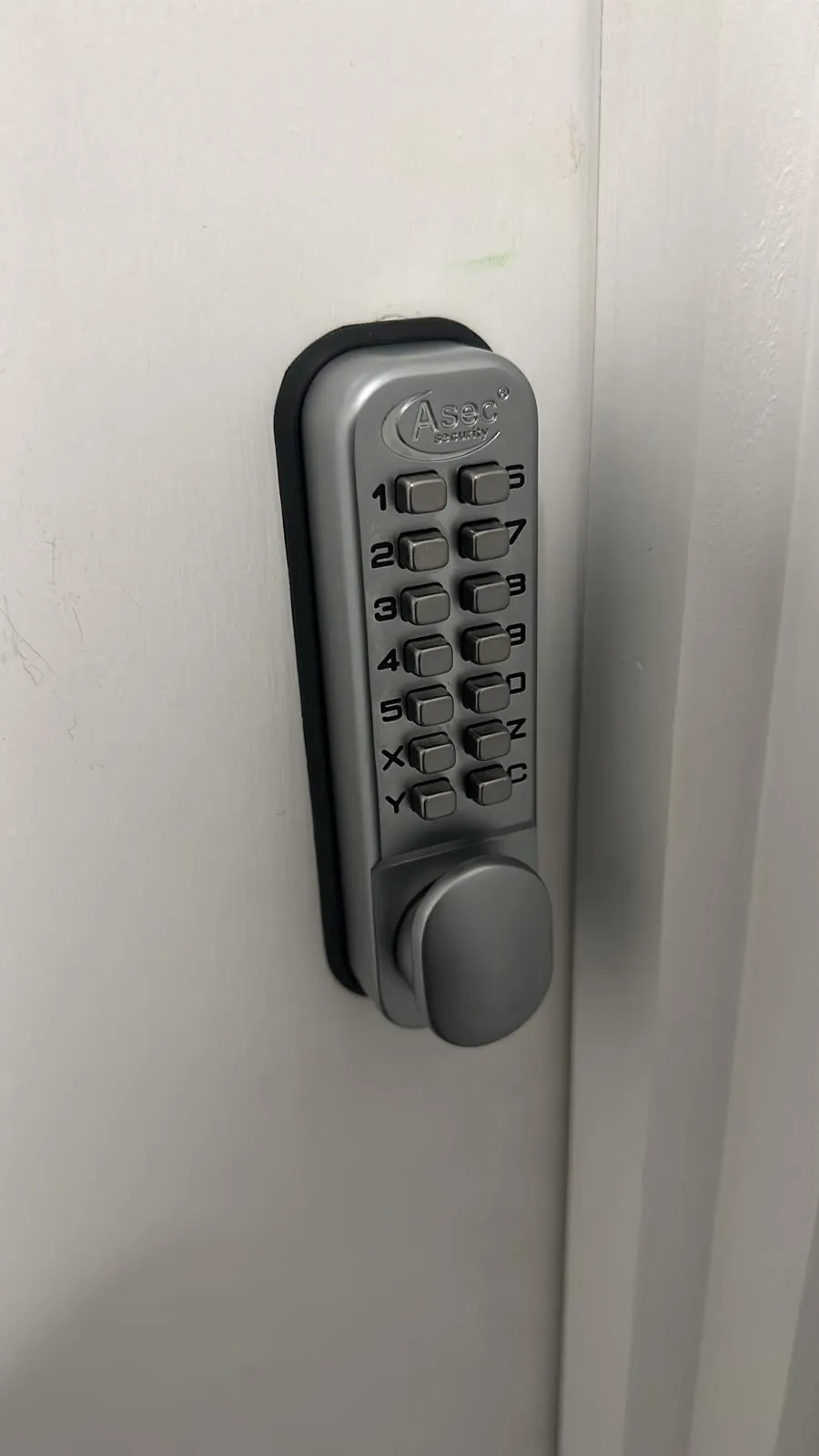 Mechanical keypad lock fitted to a white door