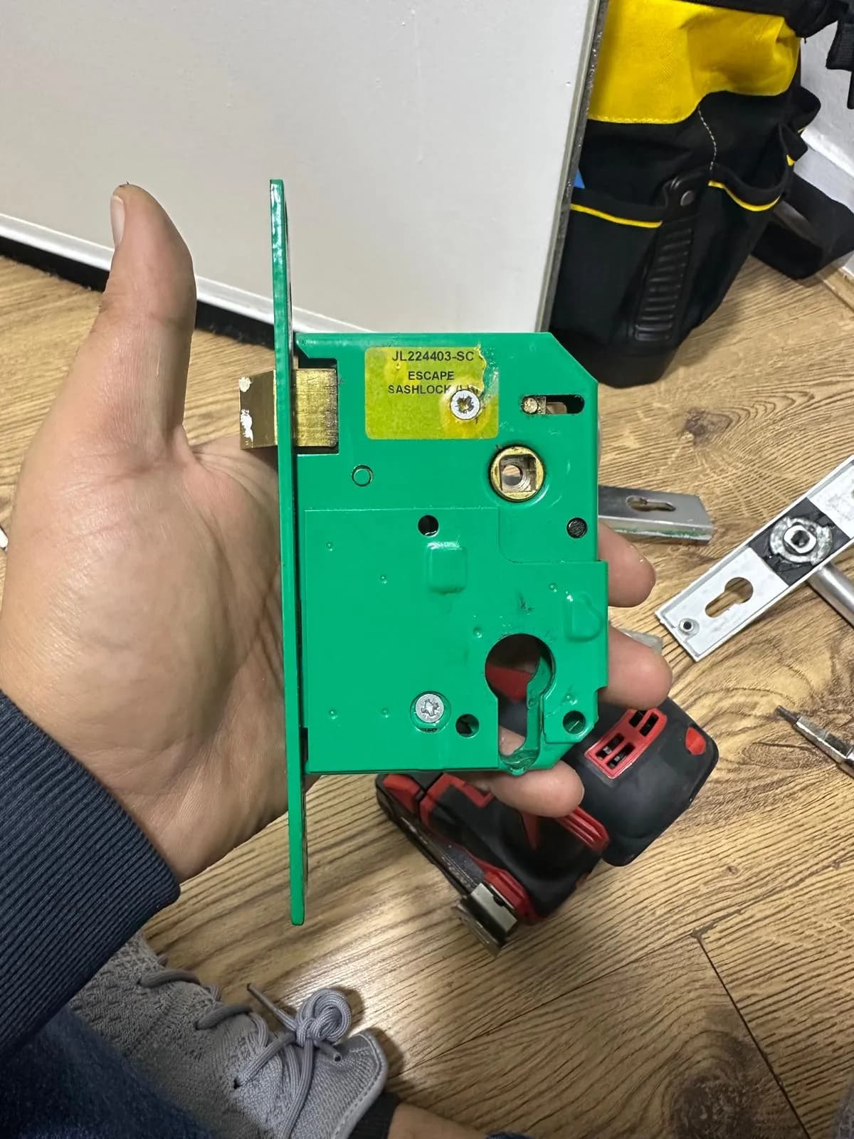 Mortice lock case held in a gloved hand