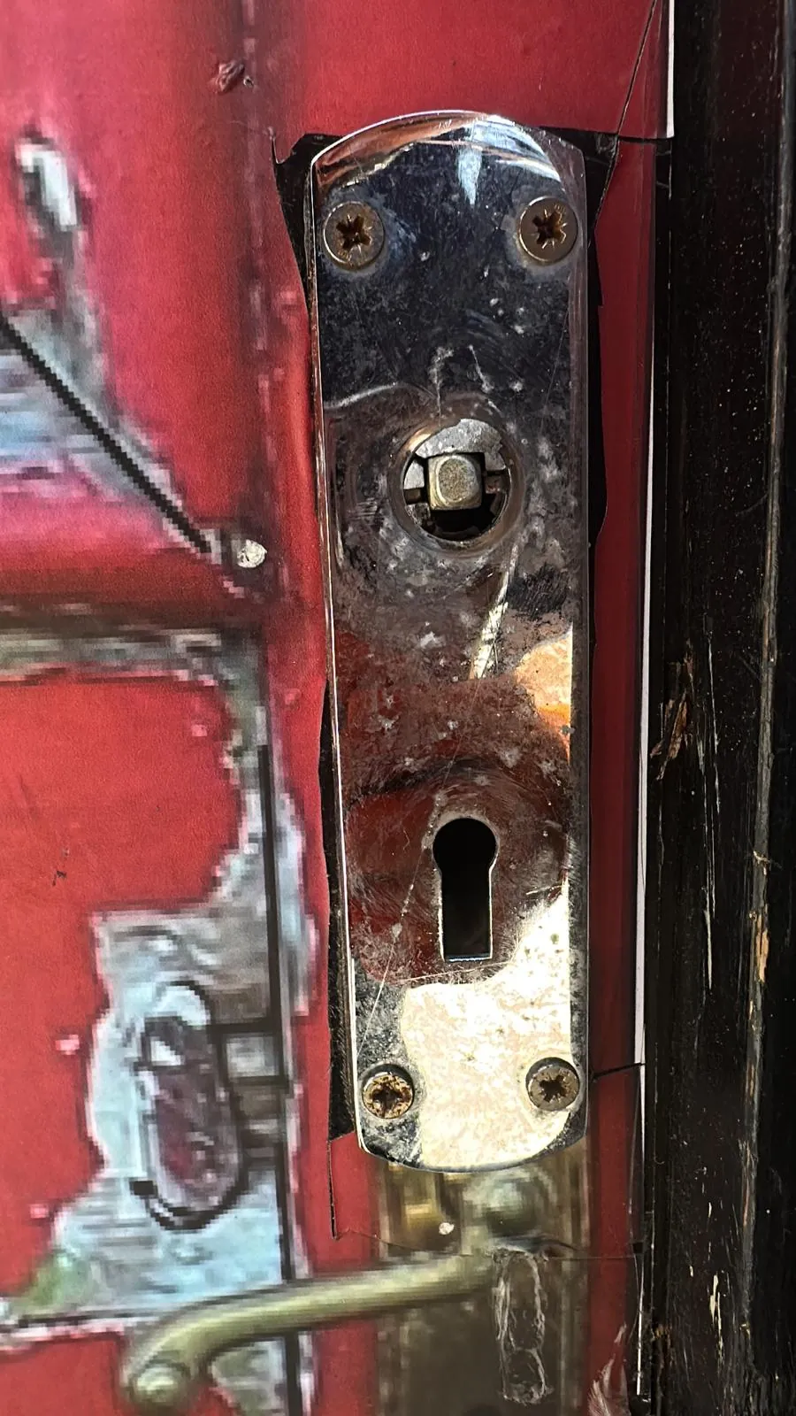 Worn lock area on a red door
